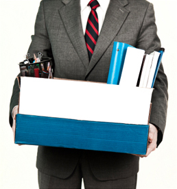 Man in suit holding a box full of office supplies