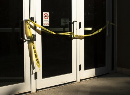 A door with caution tape on it.